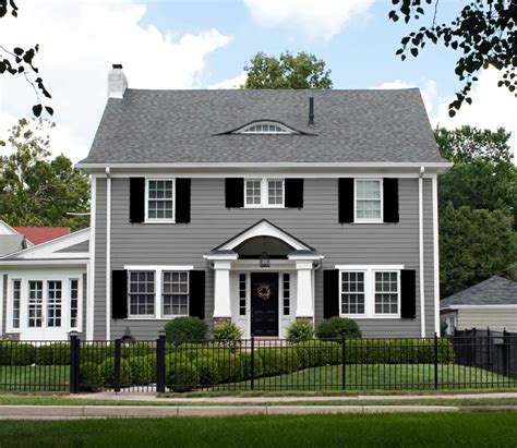 gray house and green metal roof|grey houses with black shutters.